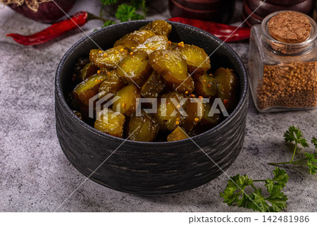 Pickled cucumber slices in black bowl with mustard seeds Pickled cucumber slices in black bowl with mustard seeds 142481986
