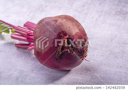 Fresh raw beetroot with stems on a grey textured background 142482039