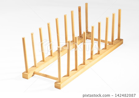 Empty bamboo dish drying rack isolated on white background Empty bamboo dish drying rack isolated on white background 142482087