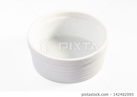 Empty white ceramic ramekin with ribbed texture isolated on white background Empty white ceramic ramekin with ribbed texture isolated on white background 142482093