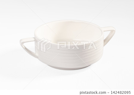 Empty white ceramic soup bowl with two handles on white background Empty white ceramic soup bowl with two handles on white background 142482095