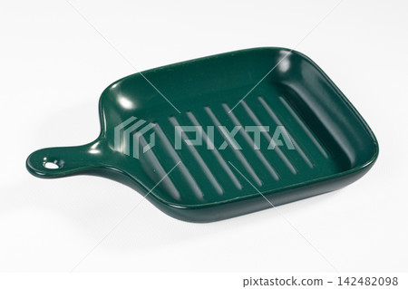 Dark green square ridged ceramic serving dish with handle isolated on white Dark green square ridged ceramic serving dish with handle isolated on white 142482098