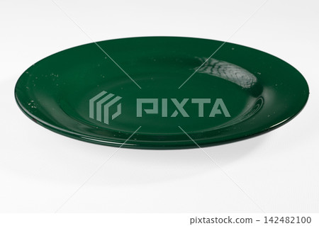 Empty dark green plate isolated on white background Empty dark green plate isolated on white background 142482100