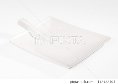Empty white ceramic serving plate with handle isolated on white background Empty white ceramic serving plate with handle isolated on white background 142482101