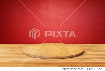 Empty wooden round podium on wood table with red background for product display. Empty wooden round podium on wood table with red background for product display. 142482154