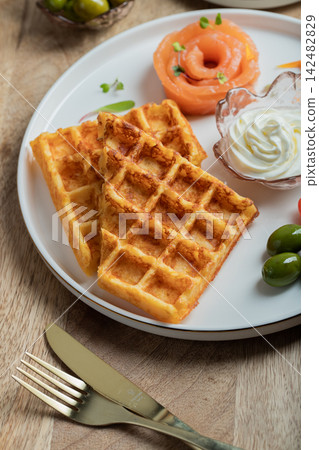 Crunchy waffle fries with sour cream dip served in a basket Crunchy waffle fries with sour cream dip served in a basket 142482829