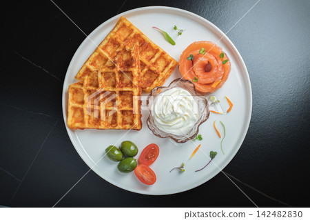 Crunchy waffle fries with sour cream dip served in a basket Crunchy waffle fries with sour cream dip served in a basket 142482830