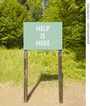 Help is here and support words symbol. Concept words Help is here on beautiful green road sign. Beautiful green forest background. Business help is here and support concept. Copy space. 142483501