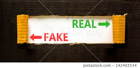 Real or fake words symbol. Concept words Fake and Real on beautiful white paper. Beautiful black background. Business and real or fake concept. Copy space. Real or fake words symbol. Concept words Fake and Real on beautiful white paper. Beautiful black background. Business and real or fake concept. Copy space. 142483534