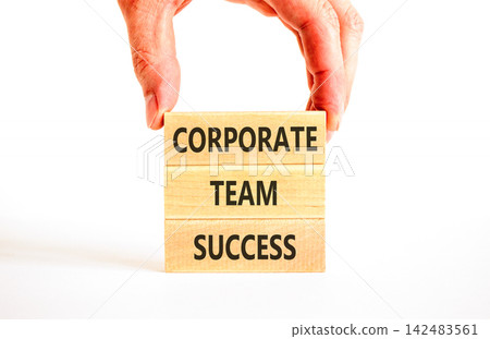 Corporate team success words symbol. Concept words Corporate team success on beautiful wooden blocks. Beautiful white background. Businessman hand. Business corporate team success concept Copy space 142483561