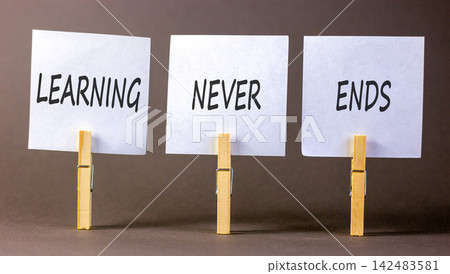 Learning never ends words symbol. Concept words Learning never ends on beautiful white papers. Beautiful grey background. Business support motivational and learning never ends concept. Copy space. Learning never ends words symbol. Concept words Learning never ends on beautiful white papers. Beautiful grey background. Business support motivational and learning never ends concept. Copy space. 142483581