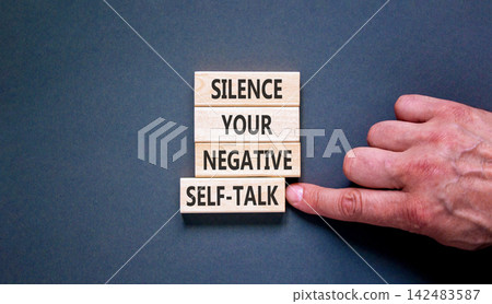 Silence your negative self-talk symbol. Concept words Silence your negative self-talk on beautiful wooden blocks. Beautiful grey background. Psychological negative self-talk concept. Copy space. Silence your negative self-talk symbol. Concept words Silence your negative self-talk on beautiful wooden blocks. Beautiful grey background. Psychological negative self-talk concept. Copy space. 142483587