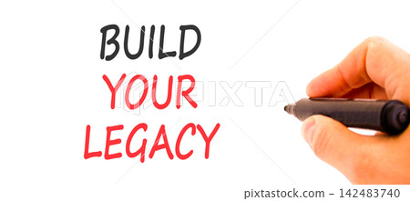 Build your legacy words symbol. Concept words Build your legacy on beautiful white paper. Beautiful white background. Businessman hand. Business build your legacy concept. Copy space. Build your legacy words symbol. Concept words Build your legacy on beautiful white paper. Beautiful white background. Businessman hand. Business build your legacy concept. Copy space. 142483740