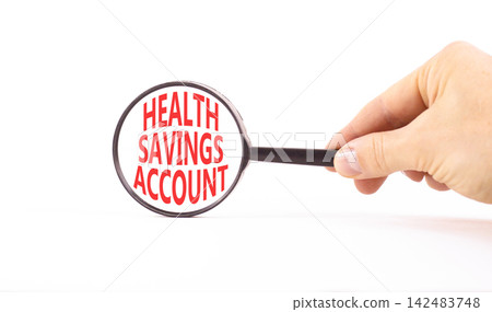 Health saving account symbol. Concept words Health saving account in beautiful magnifying glass. Beautiful white background. Businessman hand. Medical Health saving account concept. Copy space. Health saving account symbol. Concept words Health saving account in beautiful magnifying glass. Beautiful white background. Businessman hand. Medical Health saving account concept. Copy space. 142483748