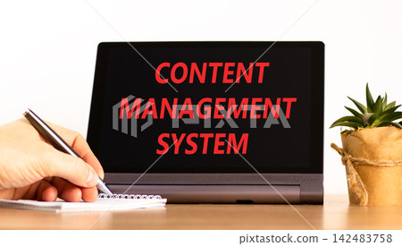 Content management system symbol. Concept words Content management system on beautiful black tablet. Beautiful white background. Businessman hand. Business content management system concept Copy space Content management system symbol. Concept words Content management system on beautiful black tablet. Beautiful white background. Businessman hand. Business content management system concept Copy space 142483758