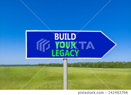 Build your legacy words symbol. Concept words Build your legacy on beautiful blue road sign. Beautiful blue sky green grass background. Business build your legacy concept. Copy space. Build your legacy words symbol. Concept words Build your legacy on beautiful blue road sign. Beautiful blue sky green grass background. Business build your legacy concept. Copy space. 142483766