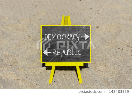 Democracy or republic words symbol. Concept words Democracy Republic on beautiful yellow blackboard. Beautiful sand beach background. Business democracy republic concept. Copy space Democracy or republic words symbol. Concept words Democracy Republic on beautiful yellow blackboard. Beautiful sand beach background. Business democracy republic concept. Copy space 142483829