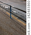 Road marking "Bicycle Lane" (viewed from the sidewalk over the guardrail) 142483860