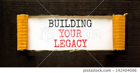 Building your legacy words symbol. Concept words Building your legacy on beautiful white paper. Beautiful black background. Business building your legacy concept. Copy space. Building your legacy words symbol. Concept words Building your legacy on beautiful white paper. Beautiful black background. Business building your legacy concept. Copy space. 142484086
