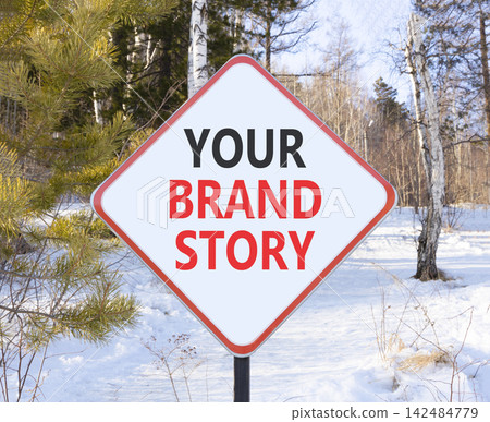 Branding and your brand story symbol. Concept words Your brand story on beautiful white road sign. Beautiful winter forest background. Business branding your brand story concept. Copy space. Branding and your brand story symbol. Concept words Your brand story on beautiful white road sign. Beautiful winter forest background. Business branding your brand story concept. Copy space. 142484779