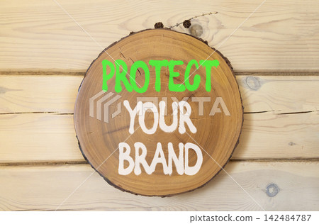 Protect your brand words symbol. Concept words Protect your brand on beautiful wooden circle. Beautiful wooden wall background. Business and protect your brand concept. Copy space. Protect your brand words symbol. Concept words Protect your brand on beautiful wooden circle. Beautiful wooden wall background. Business and protect your brand concept. Copy space. 142484787