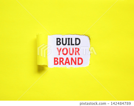 Build your brand words symbol. Concept words Build your brand on beautiful white paper. Beautiful yellow background. Business and build your brand concept. Copy space. Build your brand words symbol. Concept words Build your brand on beautiful white paper. Beautiful yellow background. Business and build your brand concept. Copy space. 142484789