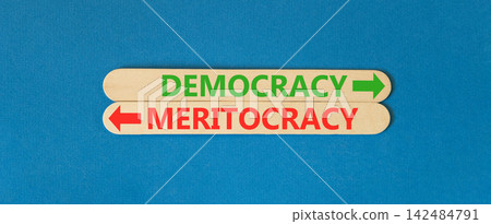 Democracy or meritocracy words symbol. Concept words Democracy Meritocracy on beautiful wooden sticks. Beautiful blue background. Business democracy meritocracy concept. Copy space Democracy or meritocracy words symbol. Concept words Democracy Meritocracy on beautiful wooden sticks. Beautiful blue background. Business democracy meritocracy concept. Copy space 142484791
