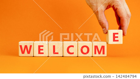 Welcome word symbol. Concept word Welcome on beautiful wooden blocks. Beautiful orange table orange background. Businessman hand. Business welcome word concept. Copy space. Welcome word symbol. Concept word Welcome on beautiful wooden blocks. Beautiful orange table orange background. Businessman hand. Business welcome word concept. Copy space. 142484794