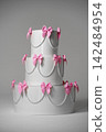 Coquette style wedding cake decor with pink bows and pearl beads on grey background 142484954