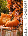 Fall Pumpkin Setup with Floral Garland and Blanket 142484967