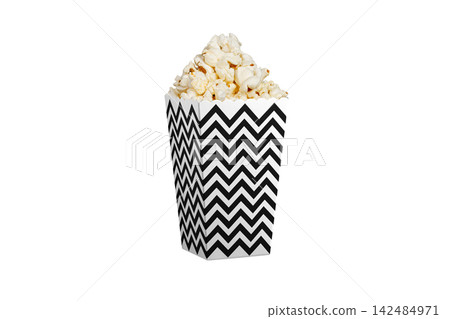 Popcorn in Black and white zigzag paper bucket isolated on white. Festive cinema snack cup. Popcorn in Black and white zigzag paper bucket isolated on white. Festive cinema snack cup. 142484971
