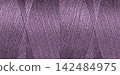 Close-up texture of Purple sewing threads on a spool 142484975