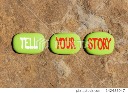 Tell your story symbol. Concept word Tell your story on beautiful green stones. Beautiful stone background. Business tell your story concept. Copy space. Tell your story symbol. Concept word Tell your story on beautiful green stones. Beautiful stone background. Business tell your story concept. Copy space. 142485047