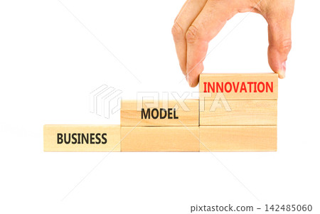 Business model innovation words symbol. Concept words Business model innovation on beautiful wooden blocks. Beautiful white background. Businessman hand. Business model innovation concept Copy space Business model innovation words symbol. Concept words Business model innovation on beautiful wooden blocks. Beautiful white background. Businessman hand. Business model innovation concept Copy space 142485060