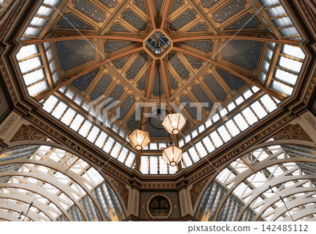 The victorian architecture design of the ceiling and colorful decorations within Leadenhall Market. The victorian architecture design of the ceiling and colorful decorations within Leadenhall Market. 142485112