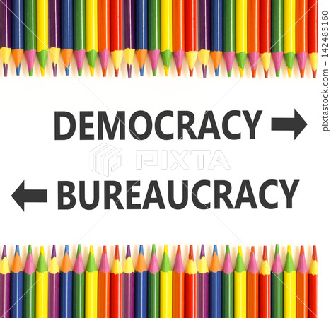 Democracy or bureaucracy words symbol. Concept words Democracy Bureaucracy on beautiful white paper. Beautiful white background. Colored pencils. Business democracy bureaucracy concept. Copy space Democracy or bureaucracy words symbol. Concept words Democracy Bureaucracy on beautiful white paper. Beautiful white background. Colored pencils. Business democracy bureaucracy concept. Copy space 142485160
