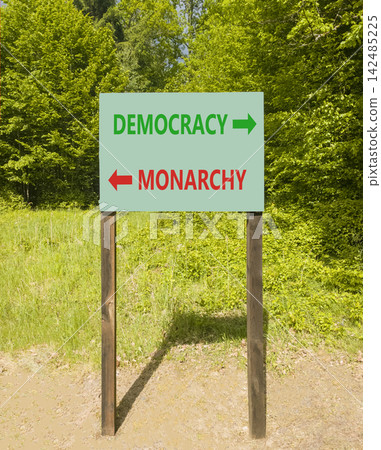 Democracy or monarchy words symbol. Concept words Democracy Monarchy on beautiful green road sign. Beautiful green forest background. Business democracy monarchy concept. Copy space Democracy or monarchy words symbol. Concept words Democracy Monarchy on beautiful green road sign. Beautiful green forest background. Business democracy monarchy concept. Copy space 142485225