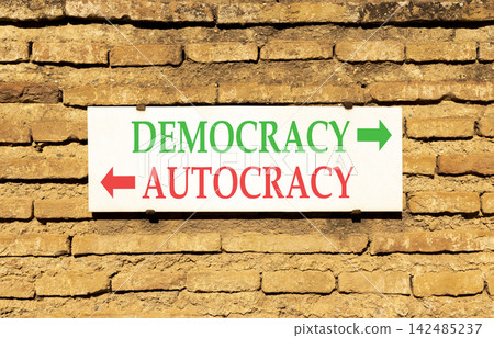 Democracy or autocracy words symbol. Concept words Democracy Autocracy on beautiful white sign plate. Beautiful brick wall background. Business democracy autocracy concept. Copy space Democracy or autocracy words symbol. Concept words Democracy Autocracy on beautiful white sign plate. Beautiful brick wall background. Business democracy autocracy concept. Copy space 142485237