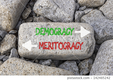 Democracy or meritocracy words symbol. Concept words Democracy Meritocracy on beautiful grey stone. Beautiful grey stones background. Business democracy meritocracy concept. Copy space Democracy or meritocracy words symbol. Concept words Democracy Meritocracy on beautiful grey stone. Beautiful grey stones background. Business democracy meritocracy concept. Copy space 142485242