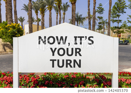 Now it's your turn words symbol. Concept words Now it's your turn on beautiful white road sign. Beautiful palm trees background. Business Now it's your turn motivational support concept Copy space Now it's your turn words symbol. Concept words Now it's your turn on beautiful white road sign. Beautiful palm trees background. Business Now it's your turn motivational support concept Copy space 142485370