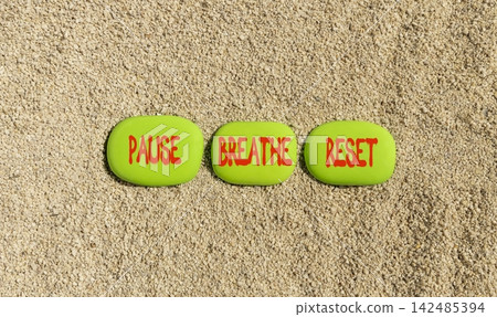 Pause breathe reset words symbol. Concept words Pause breathe reset on beautiful green stones. Beautiful sand background. Business support motivational and pause breathe reset concept. Copy space. 142485394