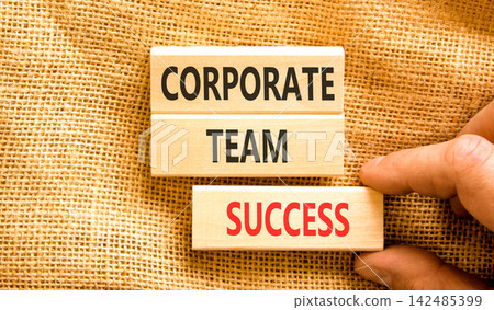 Corporate team success words symbol. Concept words Corporate team success on beautiful wooden blocks. Beautiful canvas background. Businessman hand. Business corporate team success concept Copy space 142485399