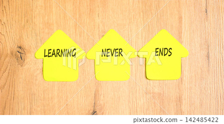 Learning never ends symbol. Concept words Learning never ends on beautiful yellow paper houses. Beautiful wooden background. Business support motivational and learning never ends concept. Copy space. Learning never ends symbol. Concept words Learning never ends on beautiful yellow paper houses. Beautiful wooden background. Business support motivational and learning never ends concept. Copy space. 142485422