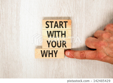 Start with your why words symbol. Concept words Start with your why on beautiful wooden blocks. Beautiful grey wooden background. Businessman hand. Business start with your why concept. Copy space. Start with your why words symbol. Concept words Start with your why on beautiful wooden blocks. Beautiful grey wooden background. Businessman hand. Business start with your why concept. Copy space. 142485429