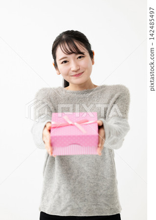 Woman with gift Woman with gift 142485497