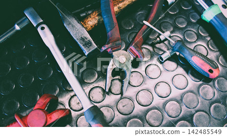 Vintage worn from time and frequent use mechanical tools on a workbench. Old tools for workshop stock image Vintage worn from time and frequent use mechanical tools on a workbench. Old tools for workshop stock image 142485549