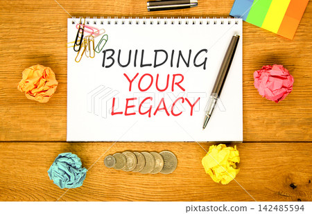 Building your legacy words symbol. Concept words Building your legacy on beautiful white note. Beautiful wooden background. Colored paper. Business building your legacy concept. Copy space. Building your legacy words symbol. Concept words Building your legacy on beautiful white note. Beautiful wooden background. Colored paper. Business building your legacy concept. Copy space. 142485594