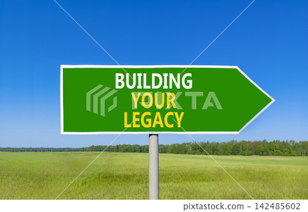 Building your legacy words symbol. Concept words Building your legacy on beautiful green road sign. Beautiful blue sky green grass background. Business building your legacy concept. Copy space. Building your legacy words symbol. Concept words Building your legacy on beautiful green road sign. Beautiful blue sky green grass background. Business building your legacy concept. Copy space. 142485602