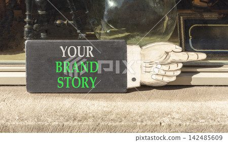 Branding and your brand story symbol. Concept words Your brand story on beautiful black information sign. Beautiful shopfront background. Business branding your brand story concept. Copy space. Branding and your brand story symbol. Concept words Your brand story on beautiful black information sign. Beautiful shopfront background. Business branding your brand story concept. Copy space. 142485609