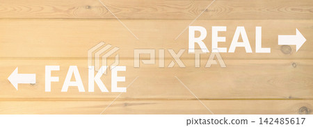 Real or fake words symbol. Concept words Fake and Real on beautiful wooden wall. Beautiful wooden wall background. Business and real or fake concept. Copy space. Real or fake words symbol. Concept words Fake and Real on beautiful wooden wall. Beautiful wooden wall background. Business and real or fake concept. Copy space. 142485617